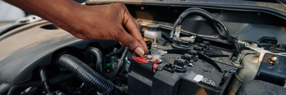 person checking a car battery