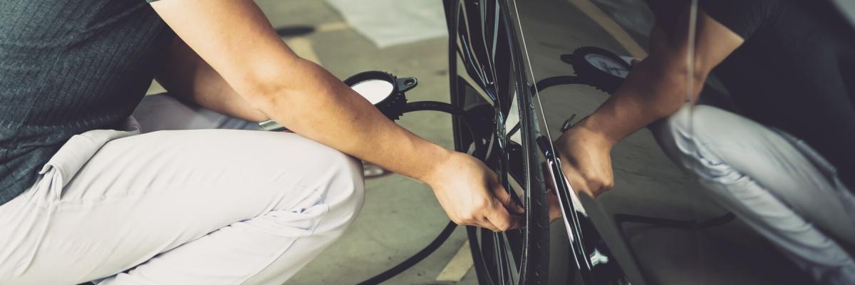 Adult man Checking tire pressure With tire gauge