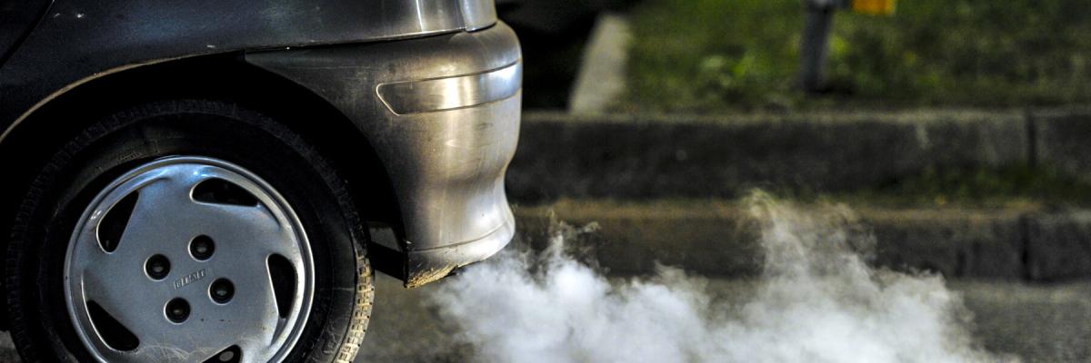 Close up of a car's fumes coming from exhaust, vehicle emissions concept
